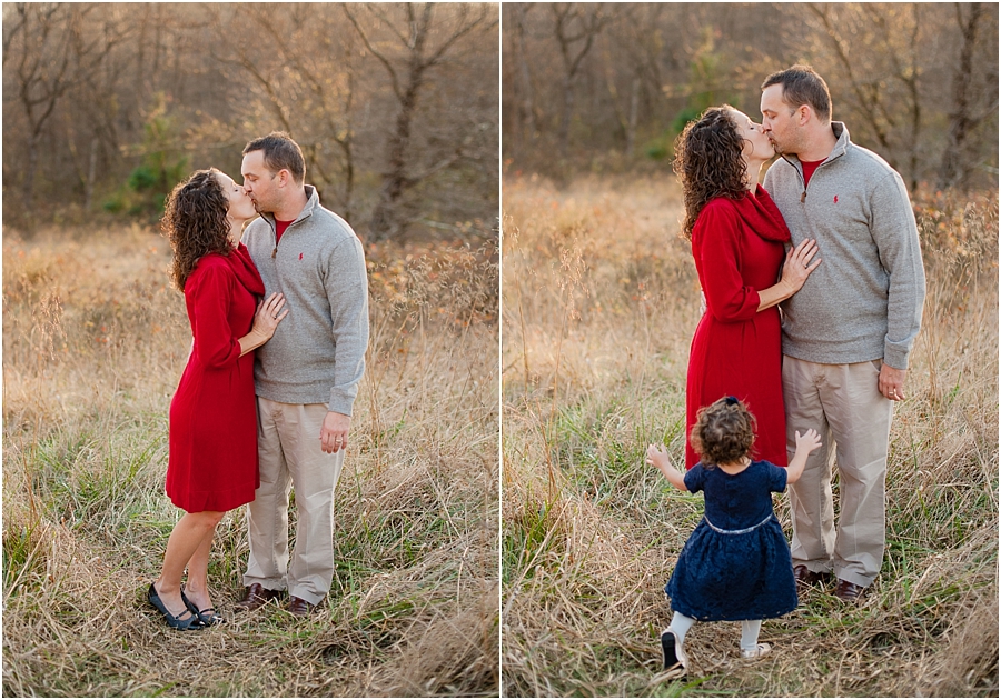 Mom and Dad kissing in field with bright red dress color pop