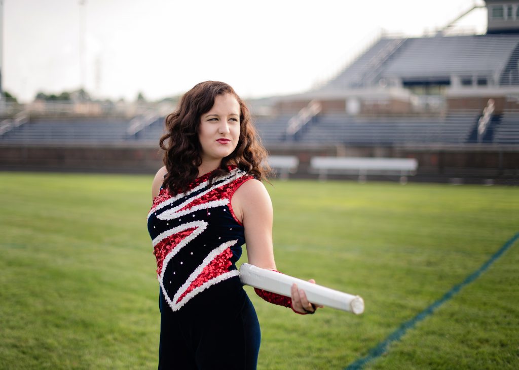 Senior Session in the Mid Ohio Valley - color guard uniform with gun on football field 