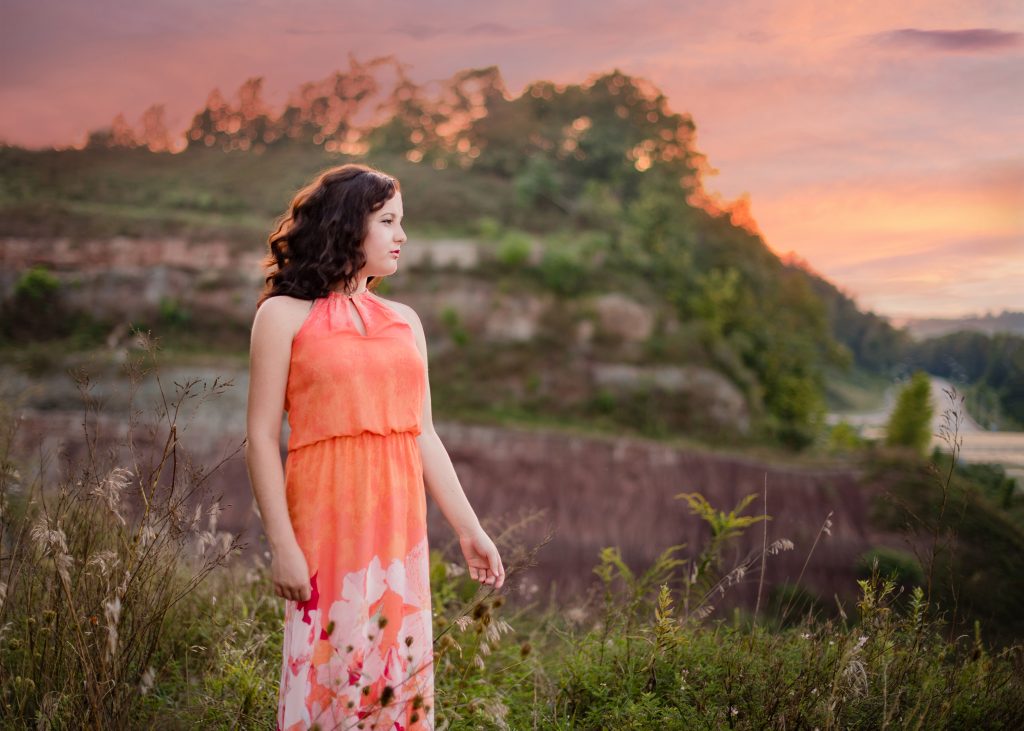 Senior Session in the Mid Ohio Valley girl in floral dress in front of sunset