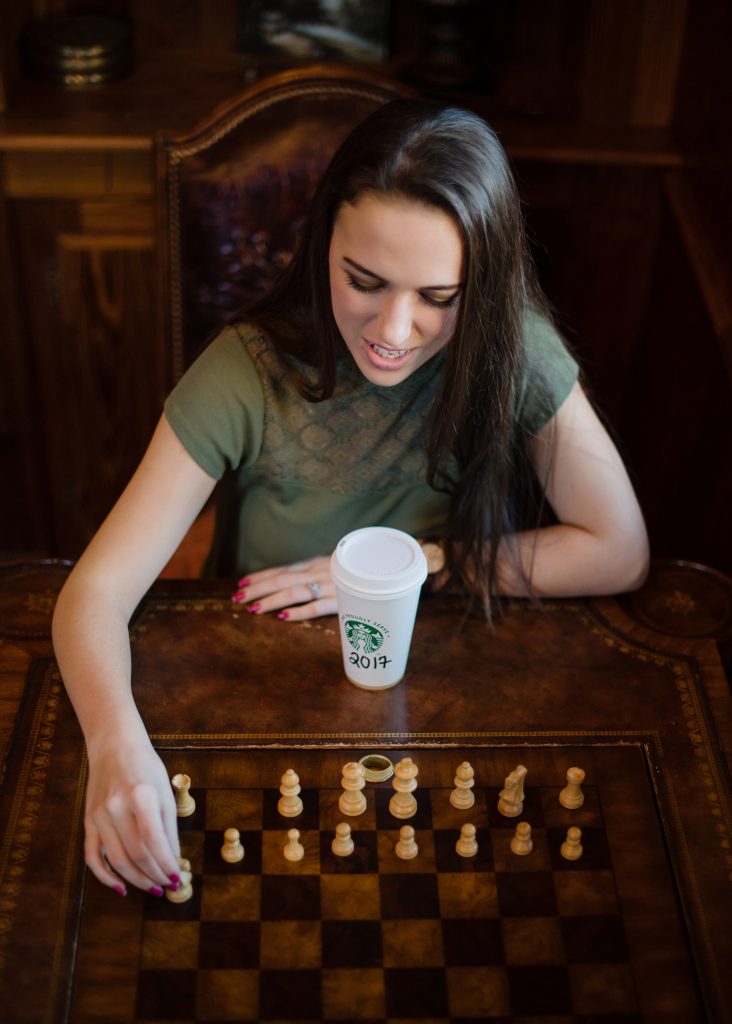 girl drinking coffee and playing chess