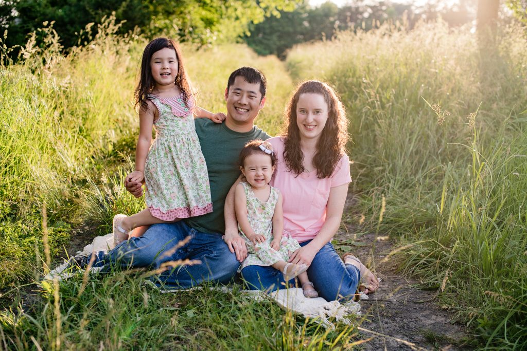 Family Session - The Higgins Family - Lori Pickens Photography - family sitting on blanket in field 