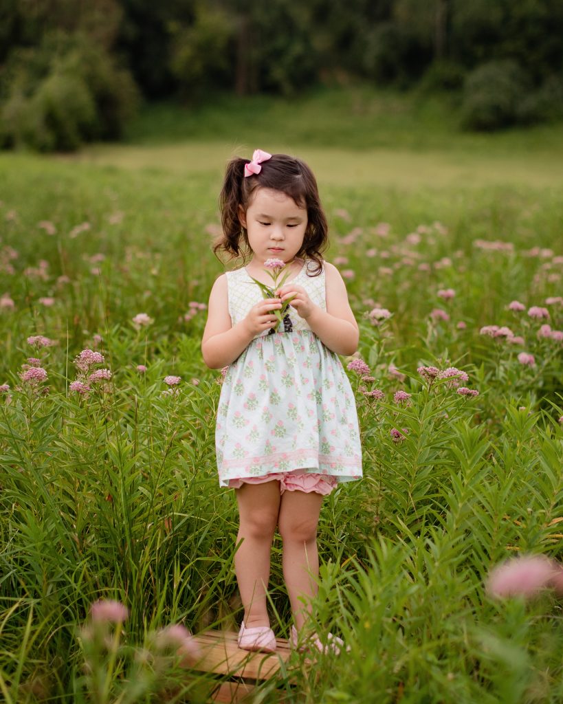 Portrait Session | The Higgins Girls | toddler smelling the flowers