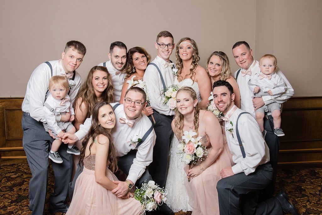 fun bridal party with champagne
pink dresses, suspenders, bow ties and little boys included 