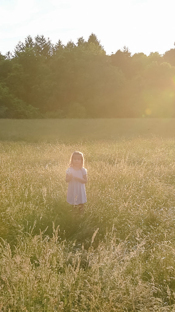 Screenshot of girl in field with hazy sunlight 
