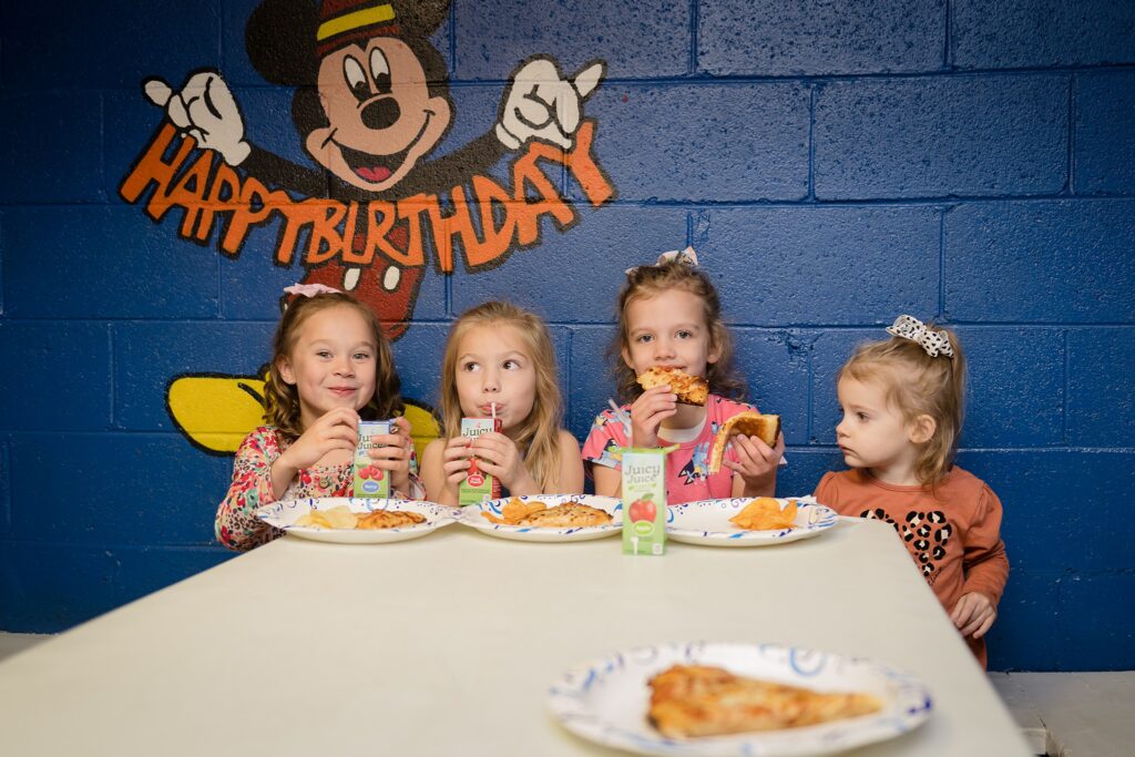 4 little girls enjoy pizza at skate country birthday party