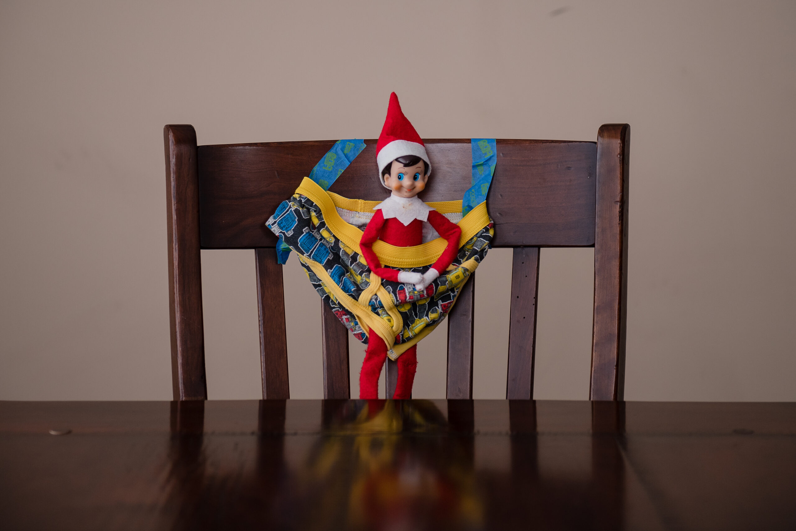Elf on the Shelf tied up to a chair in underwear