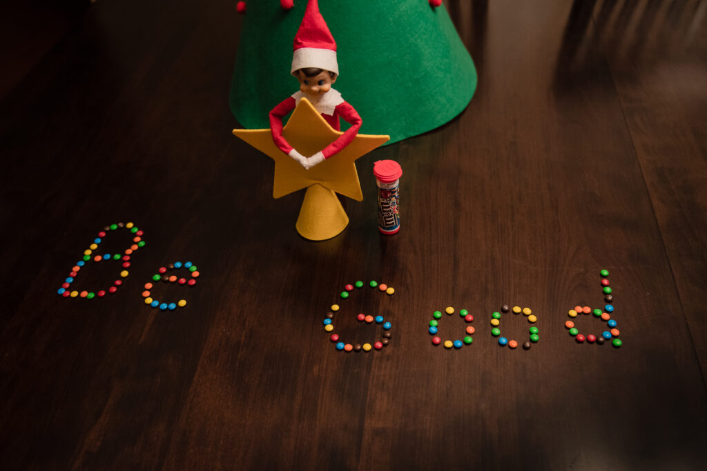 elf on the shelf with a star and wrote BE GOOD with skittles