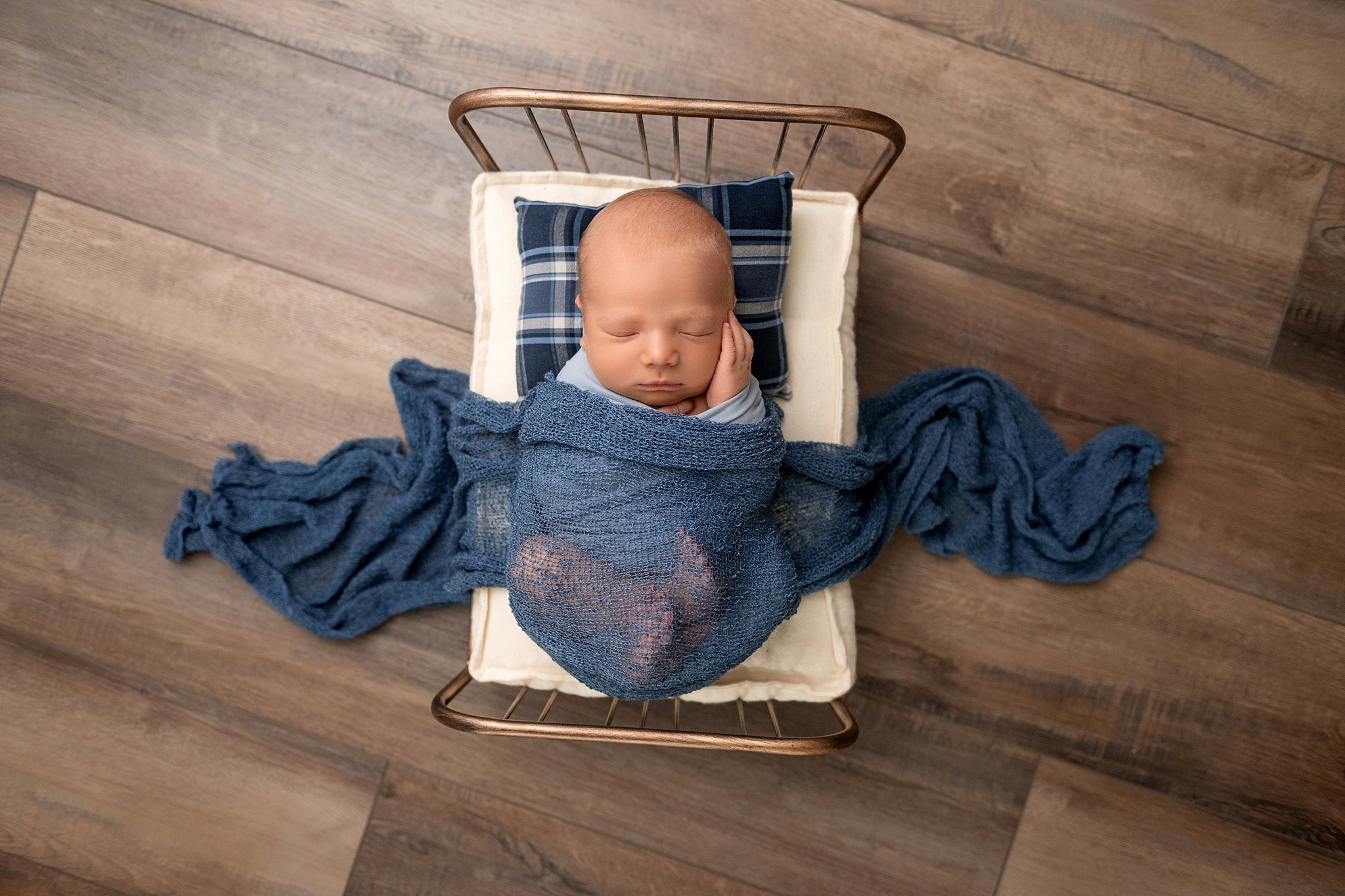 A newborn baby sleeps in a tiny bed under a blue blanket after leaving marietta memorial hospital athens ohio